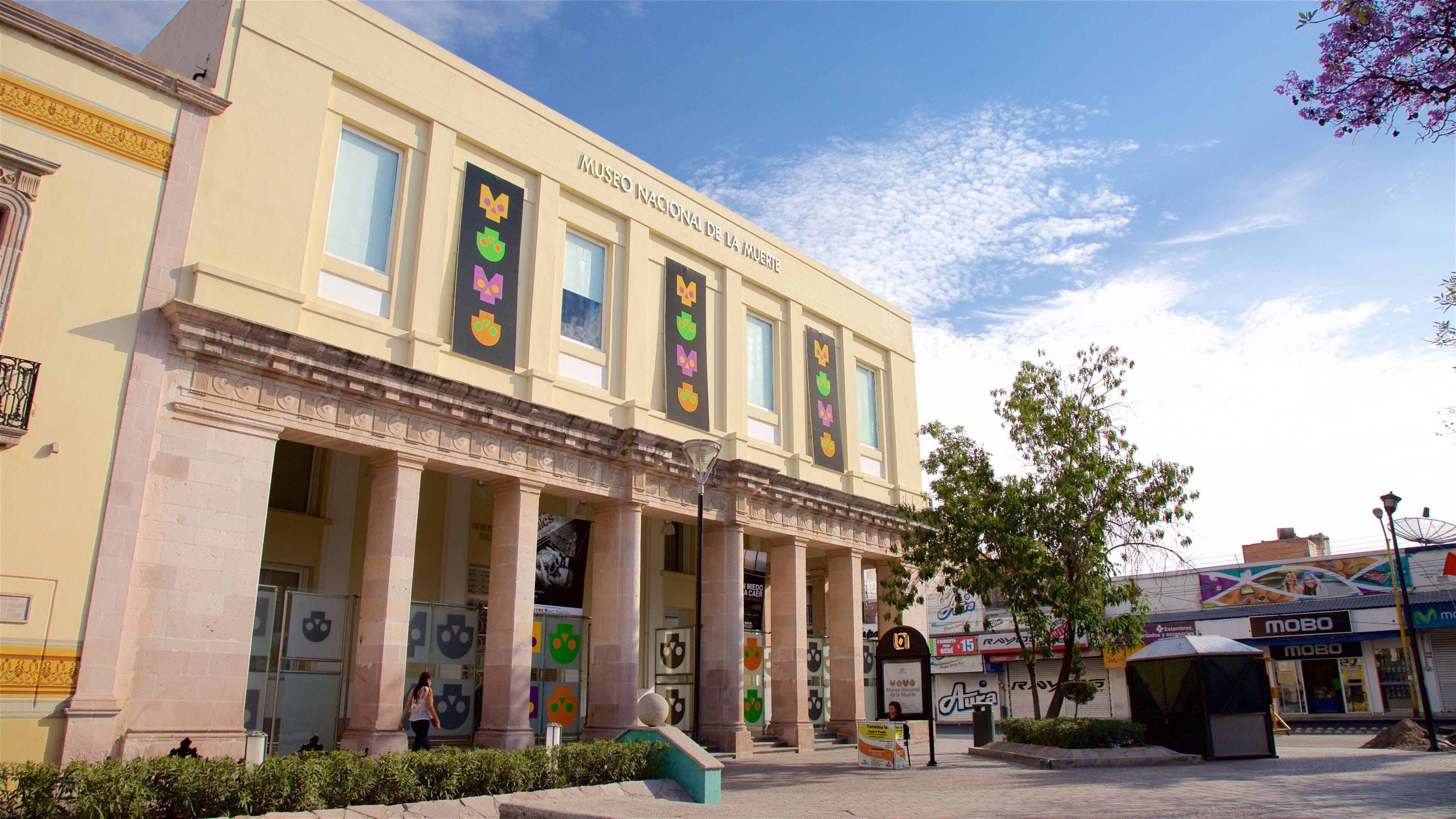 The Museo Nacional de la Mujer building with columns and colorful banners.