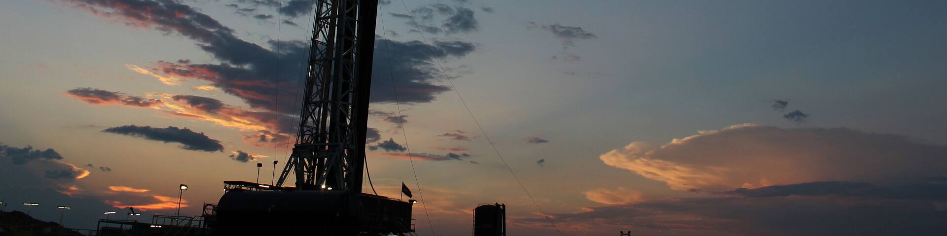 Beautiful sunset going over an oil and gas drilling rig in West Texas Permain Basin