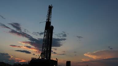 Beautiful sunset going over an oil and gas drilling rig in West Texas Permain Basin