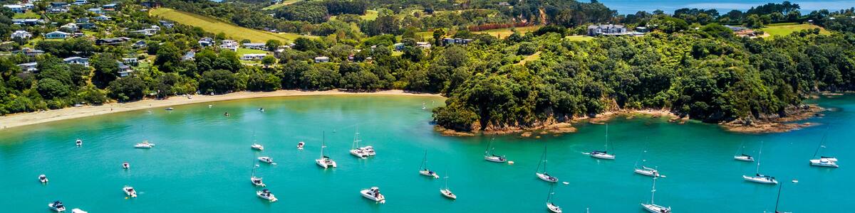 Aerial view on beautiful bay at sunny day with sandy beach and residential suburbs on the background. Waiheke Island, Auckland, New Zealand, Shutterstock ID 1020099256, Purchase Order: -