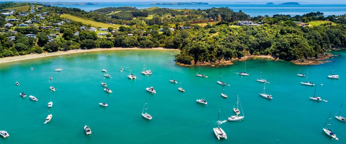 Aerial view on beautiful bay at sunny day with sandy beach and residential suburbs on the background. Waiheke Island, Auckland, New Zealand, Shutterstock ID 1020099256, Purchase Order: -