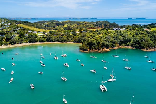Aerial view on beautiful bay at sunny day with sandy beach and residential suburbs on the background. Waiheke Island, Auckland, New Zealand, Shutterstock ID 1020099256, Purchase Order: -