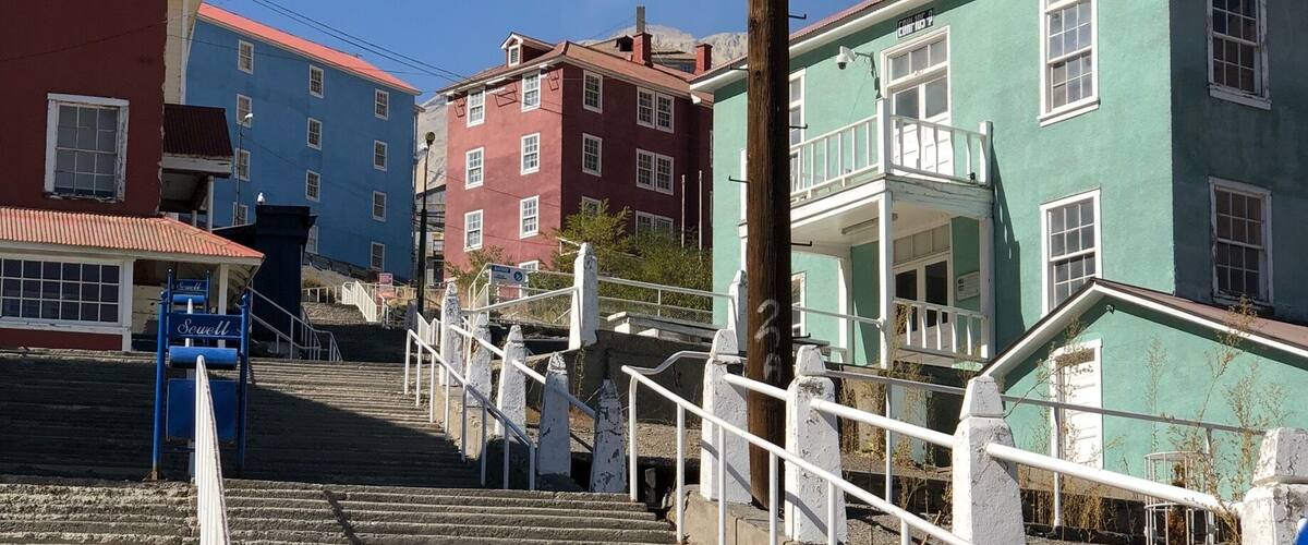 A staircase leading up to a building with a 'Sewell' sign.