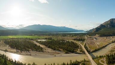 A river winding through a valley with mountains in the background.