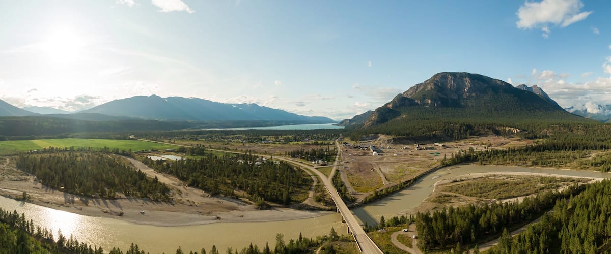 A river winding through a valley with mountains in the background.