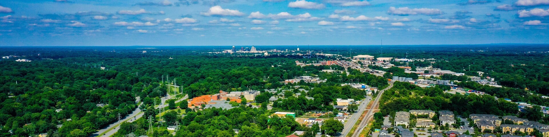 Aerial shot of Greensboro in North Carolina on the horizon from the West