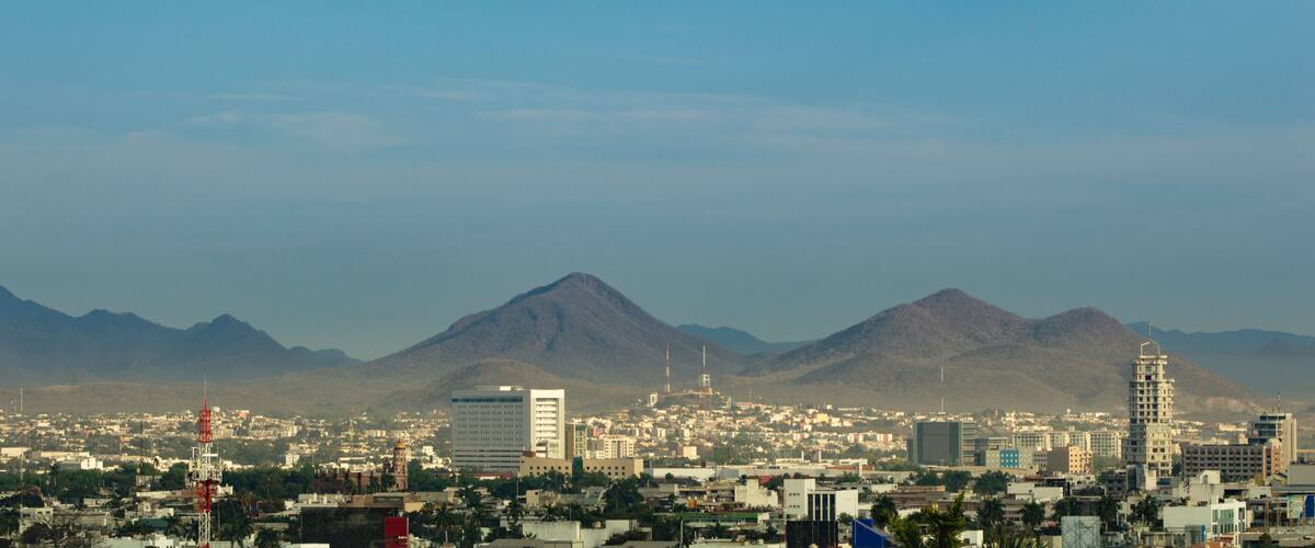 A cityscape with mountains in the background.