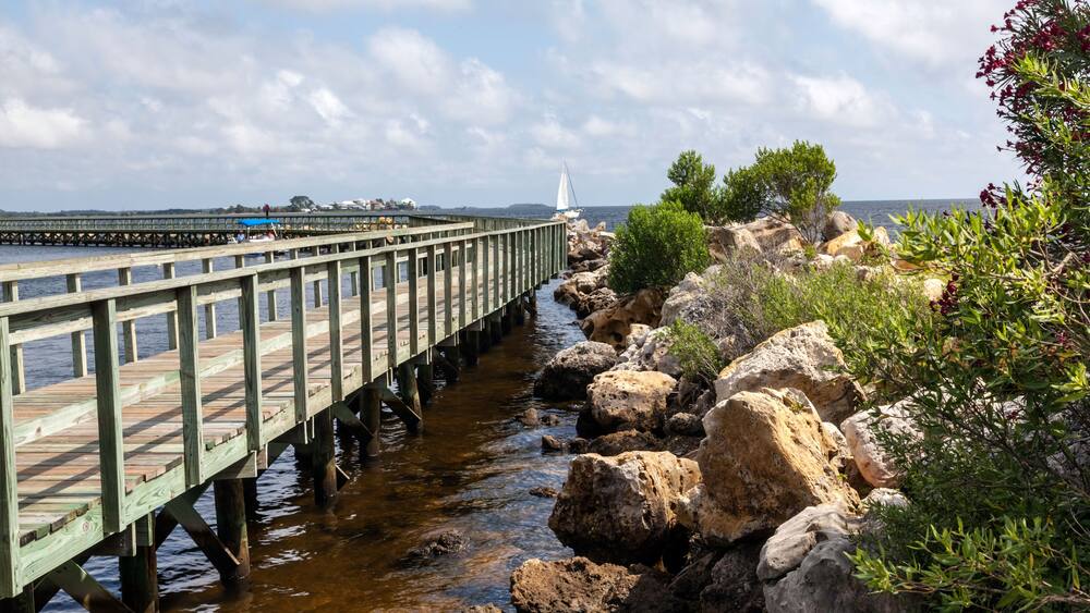 D9JK1Y Fishing pier and rock jetty at Keaton Beach on the Gulf of Mexico.