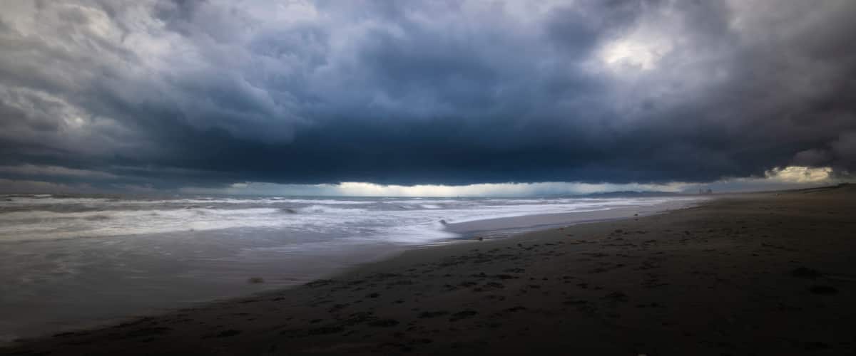 A beach with a stormy sky.