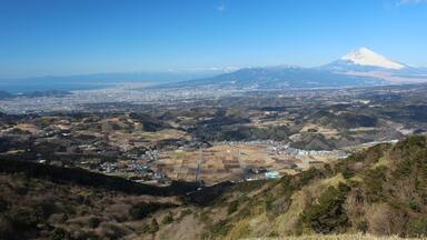 A panoramic view of a city with a prominent mountain in the background.