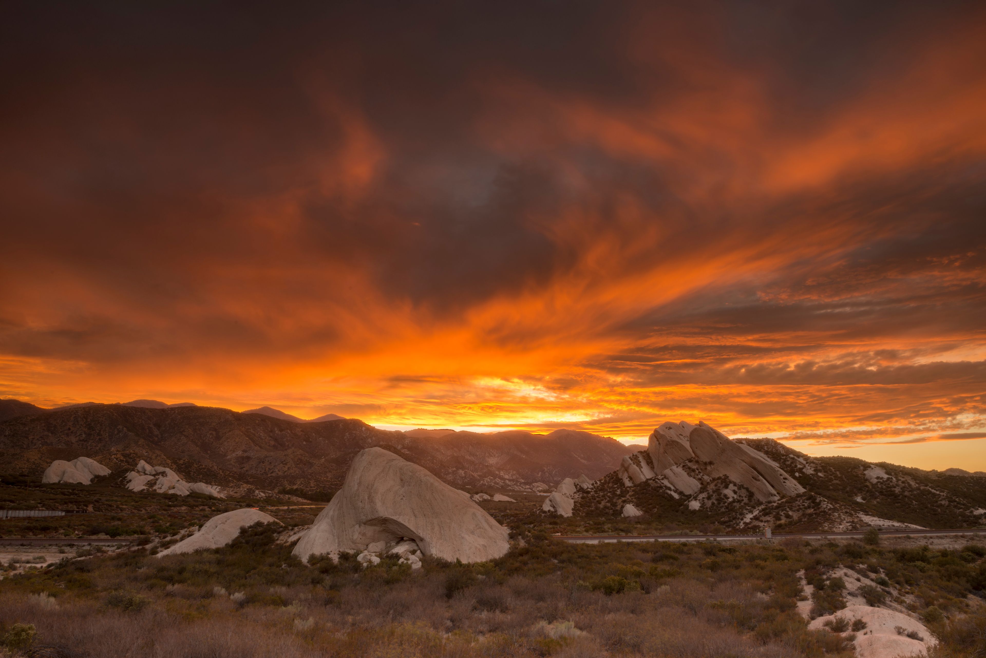A fiery sunset over the Mormon Rocks along Interstate 15 in the Cajon Pass in the Angeles Mountains CA.