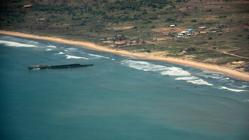 Aerial view of a disassembled ship wreckage off the coast of Ghana