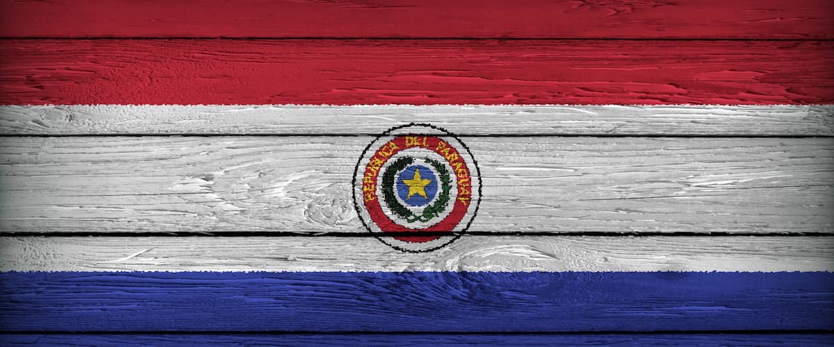 A wooden surface with horizontal stripes in red, white, and blue, featuring a central emblem.
