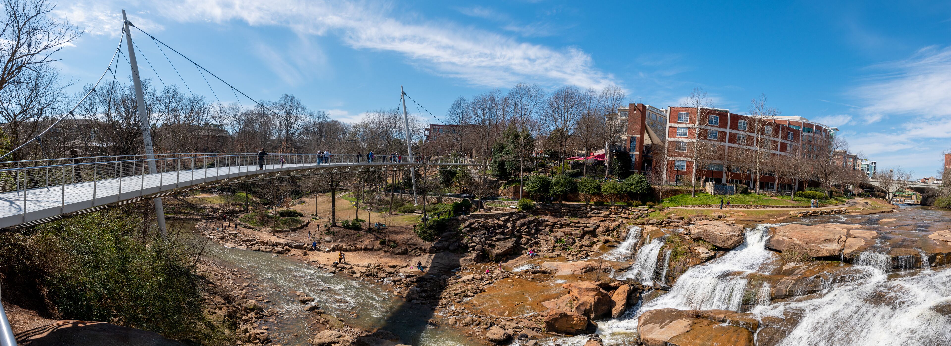A panoramic view of the Liberty Bridge crossing the Reedy River Falls in Greenville, South Carolina