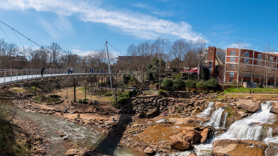 A panoramic view of the Liberty Bridge crossing the Reedy River Falls in Greenville, South Carolina