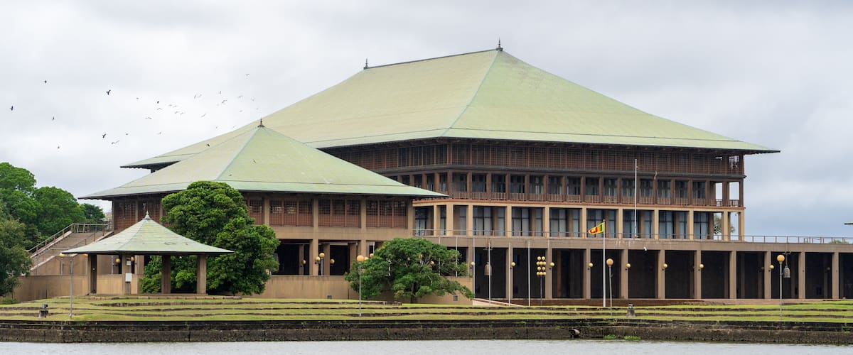 A large building with a green roof and a smaller structure with a green roof nearby.