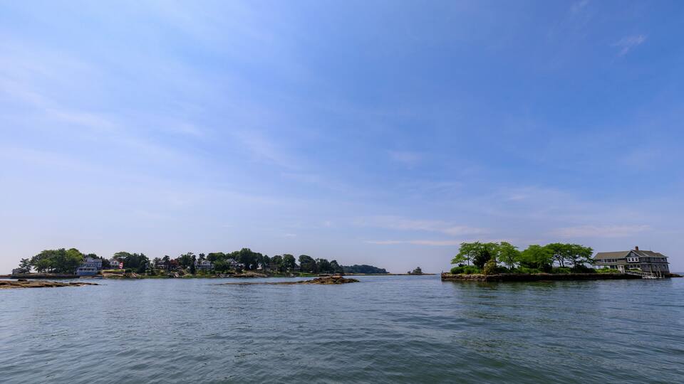 Waterfront homes on small islands under a clear blue sky