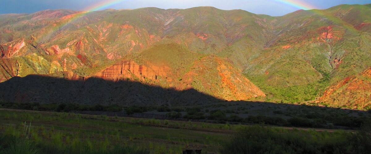 A mountain range with a rainbow.