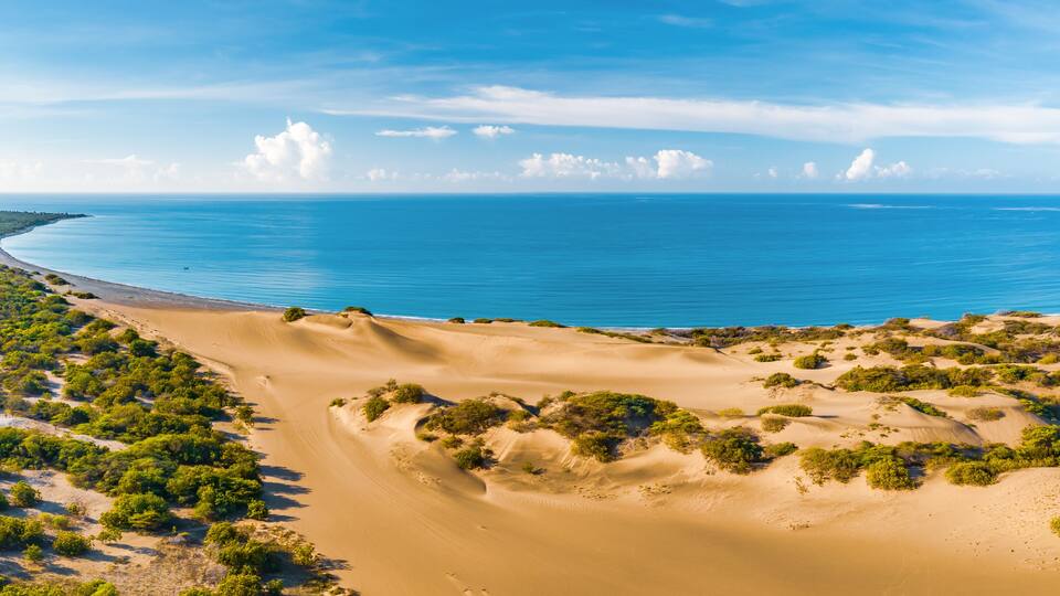 Panoramic aerial view of the dunes of Bani on a sunny day with the Caribbean Sea behind on a sunny day, Peravia, Dominican Republic