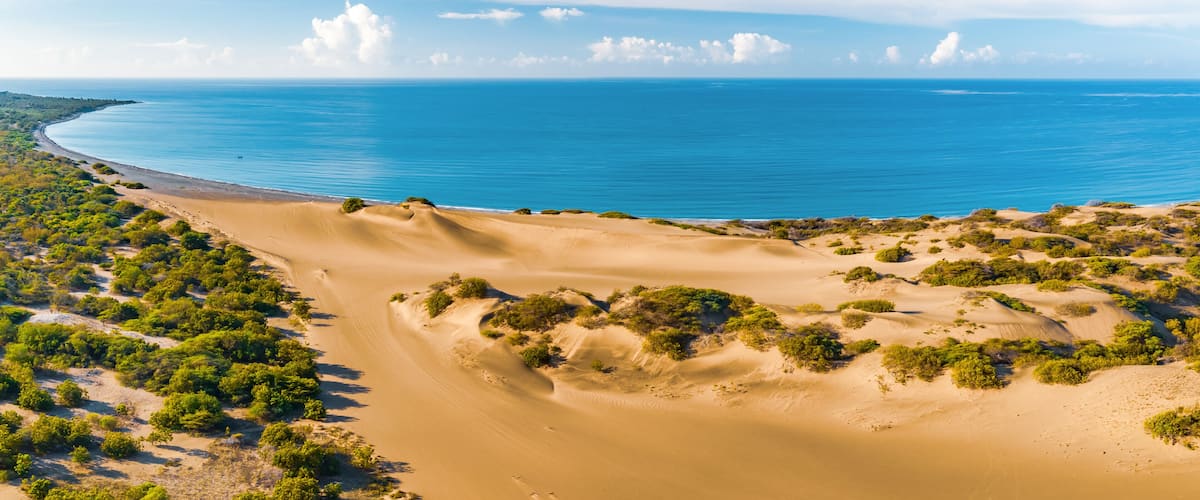 Panoramic aerial view of the dunes of Bani on a sunny day with the Caribbean Sea behind on a sunny day, Peravia, Dominican Republic