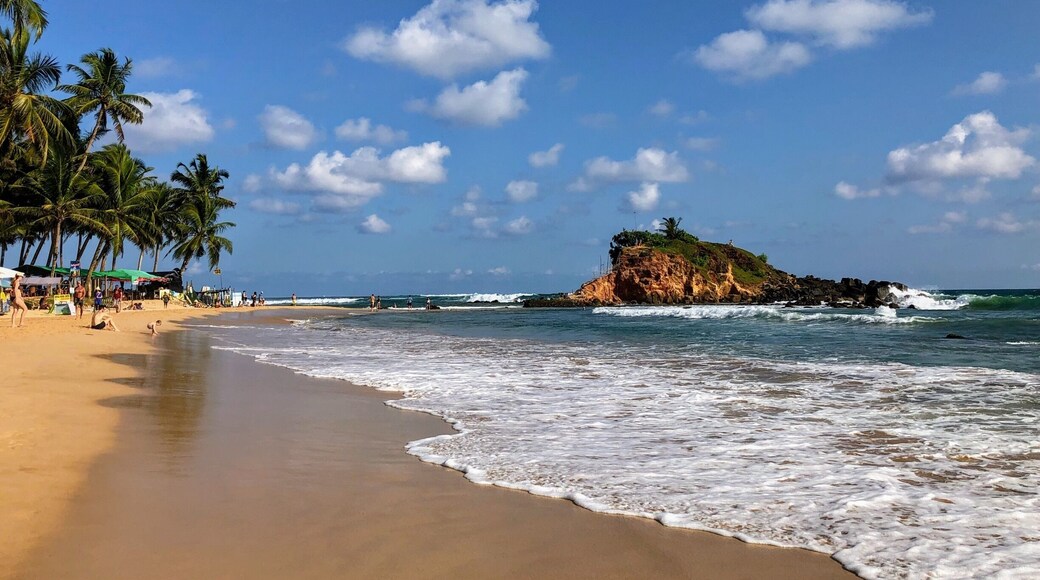 The main beach in Mirissa. Some strong waves. Plenty of bars and restaurants to keep you fed and hydrated. Stunning.