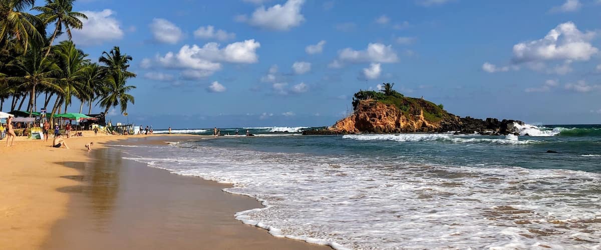 The main beach in Mirissa. Some strong waves. Plenty of bars and restaurants to keep you fed and hydrated. Stunning.