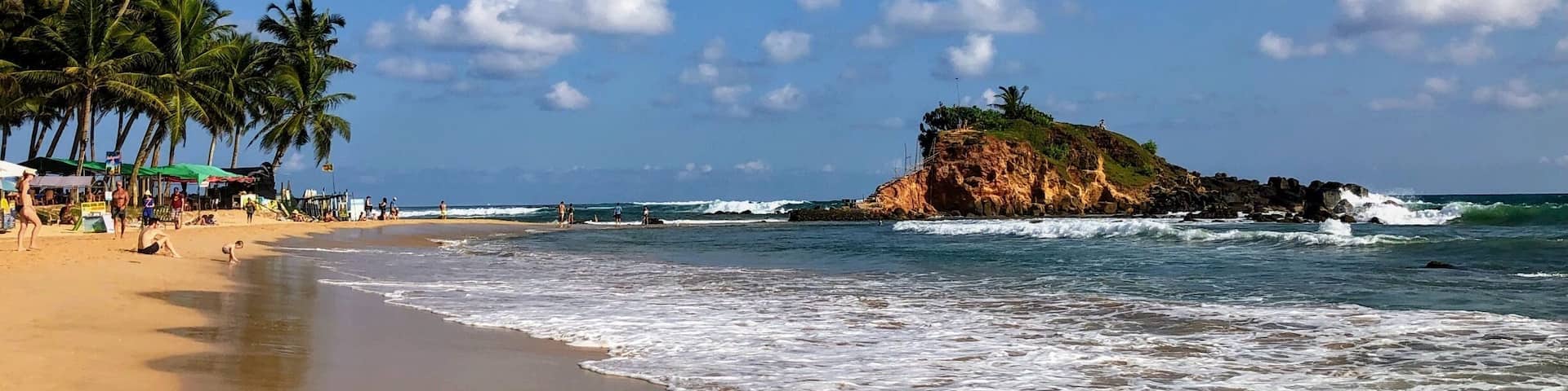 The main beach in Mirissa. Some strong waves. Plenty of bars and restaurants to keep you fed and hydrated. Stunning.