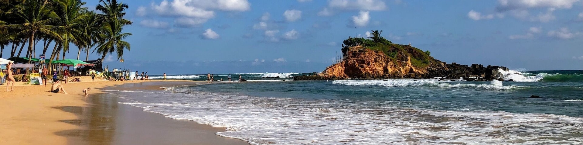 The main beach in Mirissa. Some strong waves. Plenty of bars and restaurants to keep you fed and hydrated. Stunning.