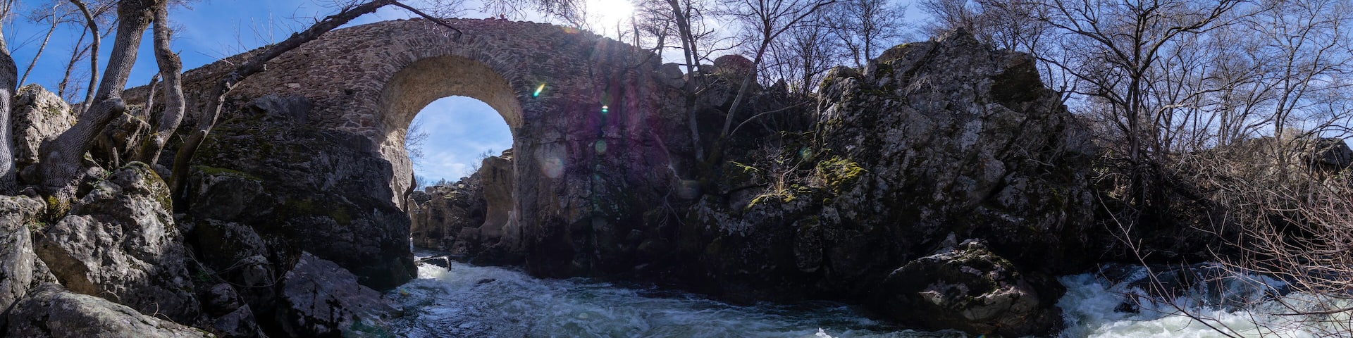 Panoramic view of the course of the Canencia stream when arriving at the Puente del Congosto, medieval bridge of Lozoya, Madrid, Spain