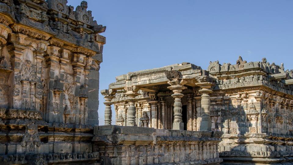 A detailed stone temple with intricate carvings and multiple pillars.