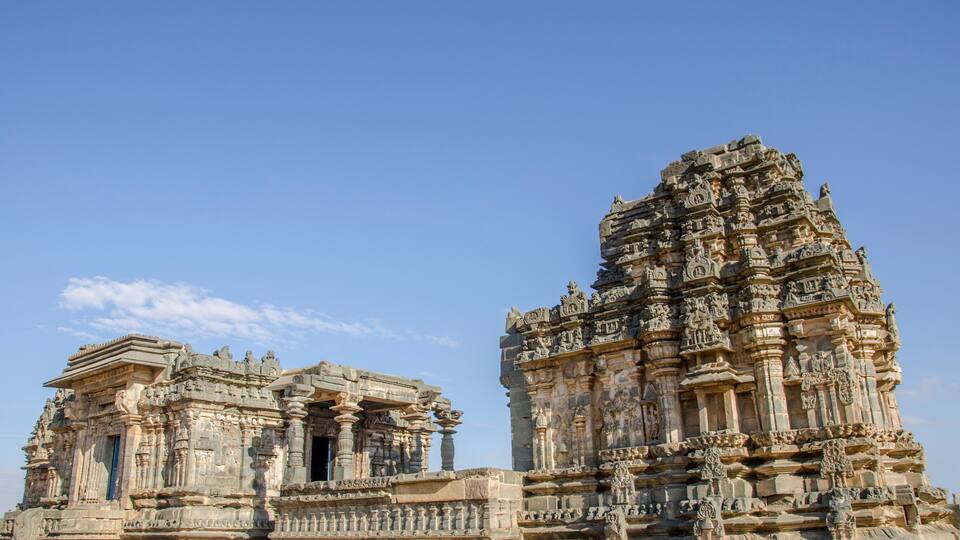 A temple with intricate carvings and a clear blue sky.