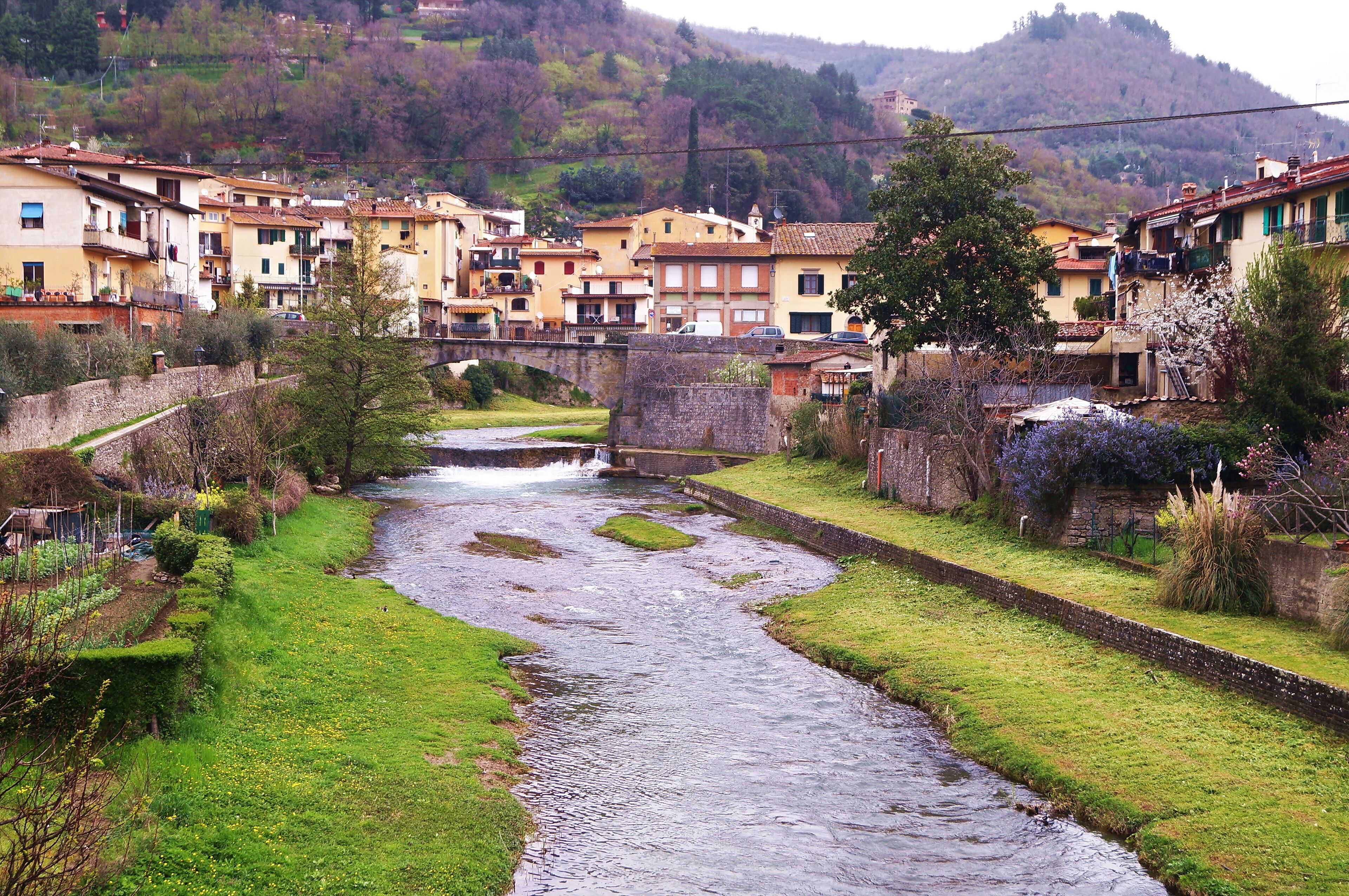 A river flowing through a town with buildings on both sides.