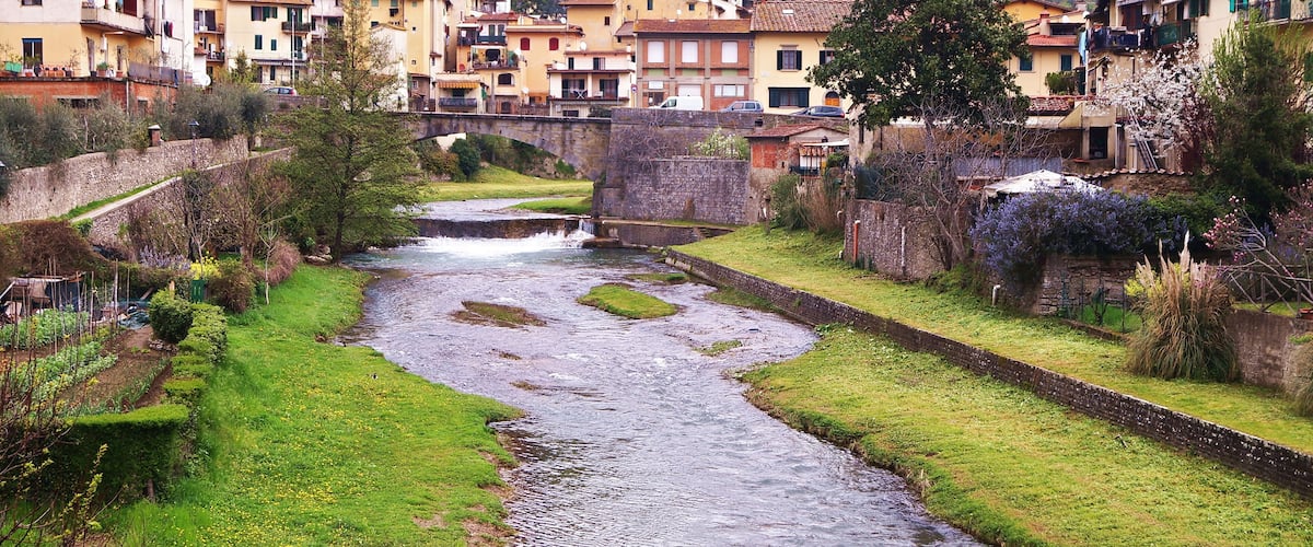 A river flowing through a town with buildings on both sides.