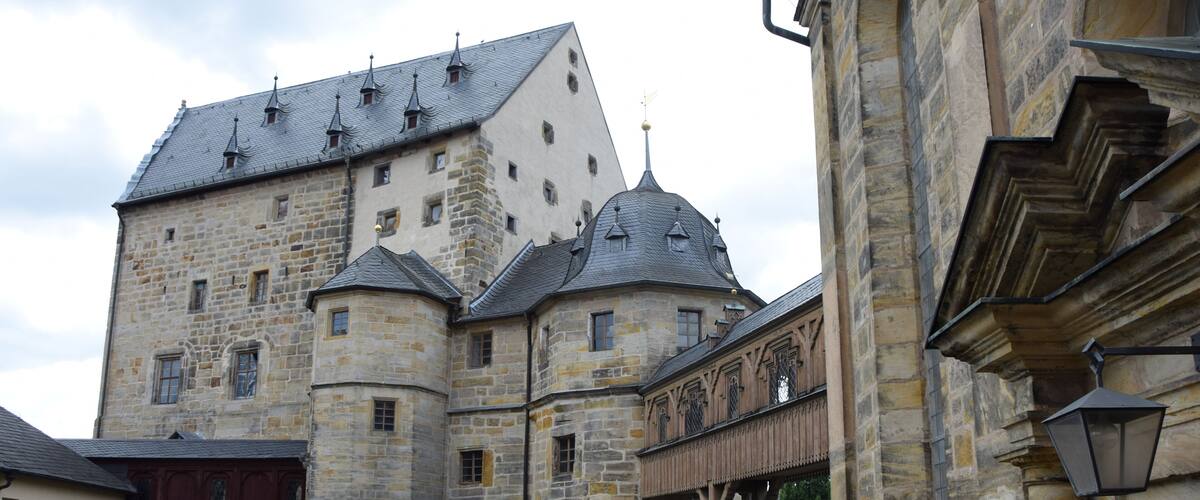 A historic stone castle with multiple towers and a prominent central tower.
