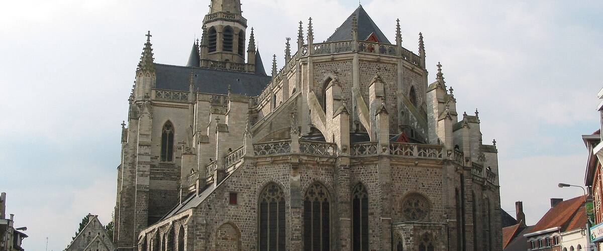 A historic cathedral with a tall spire and intricate architecture.