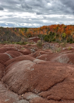 Once upon a time this area was occupied by a large river and later on poor farming took over in the 1930s that lead to soil erosions. The reddish hue of these formations are due to iron oxide deposits and the hills signify the riverbed.