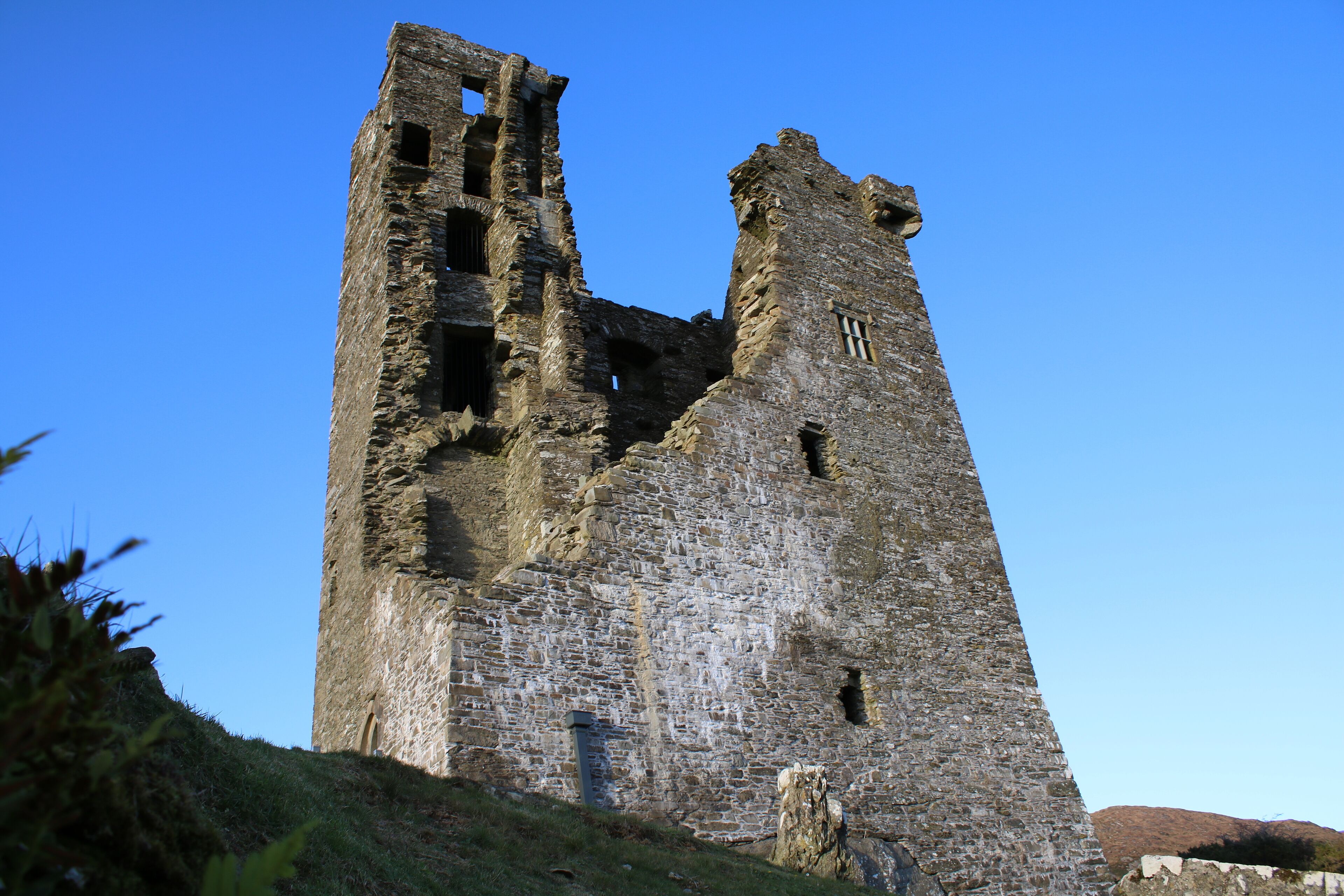 A historic stone tower with visible damage and decay.