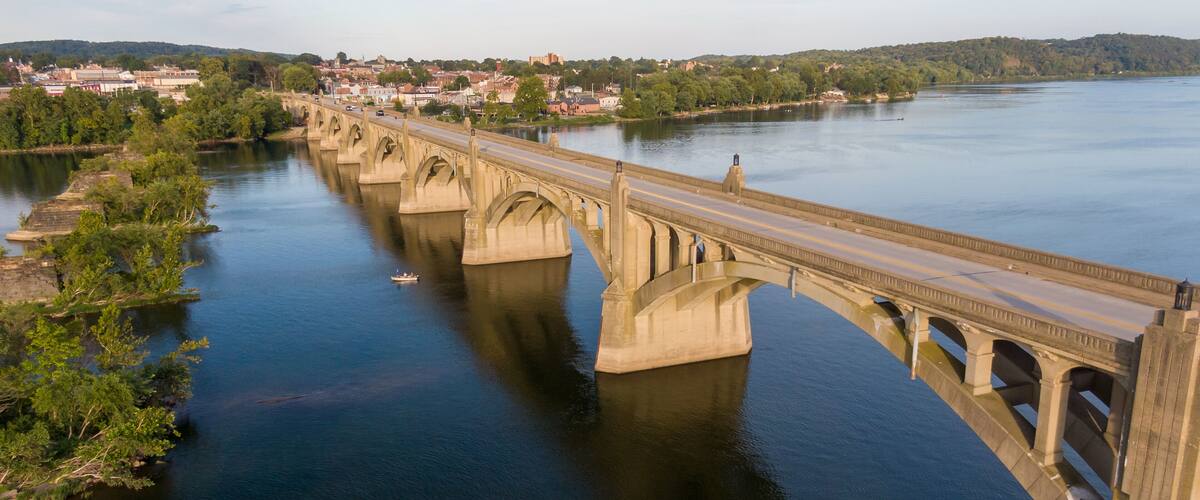 Arched bridge across river, classic architecture, aerial view