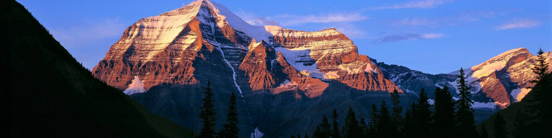 Canada, British Columbia, Mt Robson. The striation on Mount Robson, a World Heritage Site, is accentuated by the sunset light, in British Columbia, Canada.