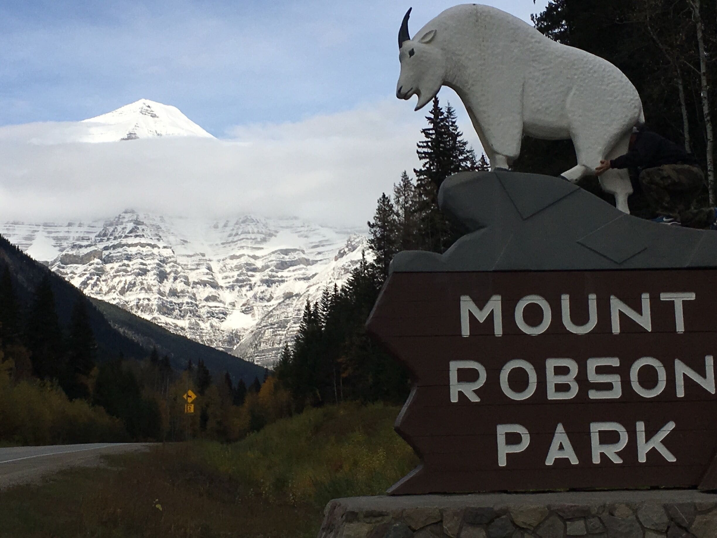 A sign for Mount Robson Park with a mountain in the background.