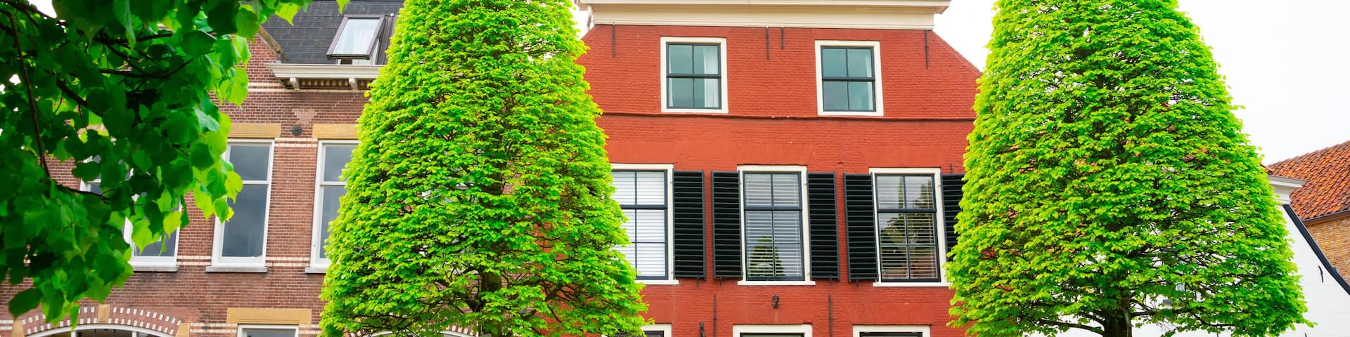 orange house with shutters in Maasland, The Netherlands