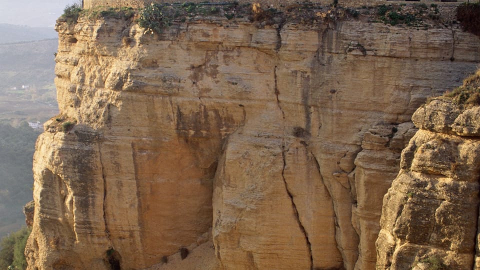 A cliff with a building on top.