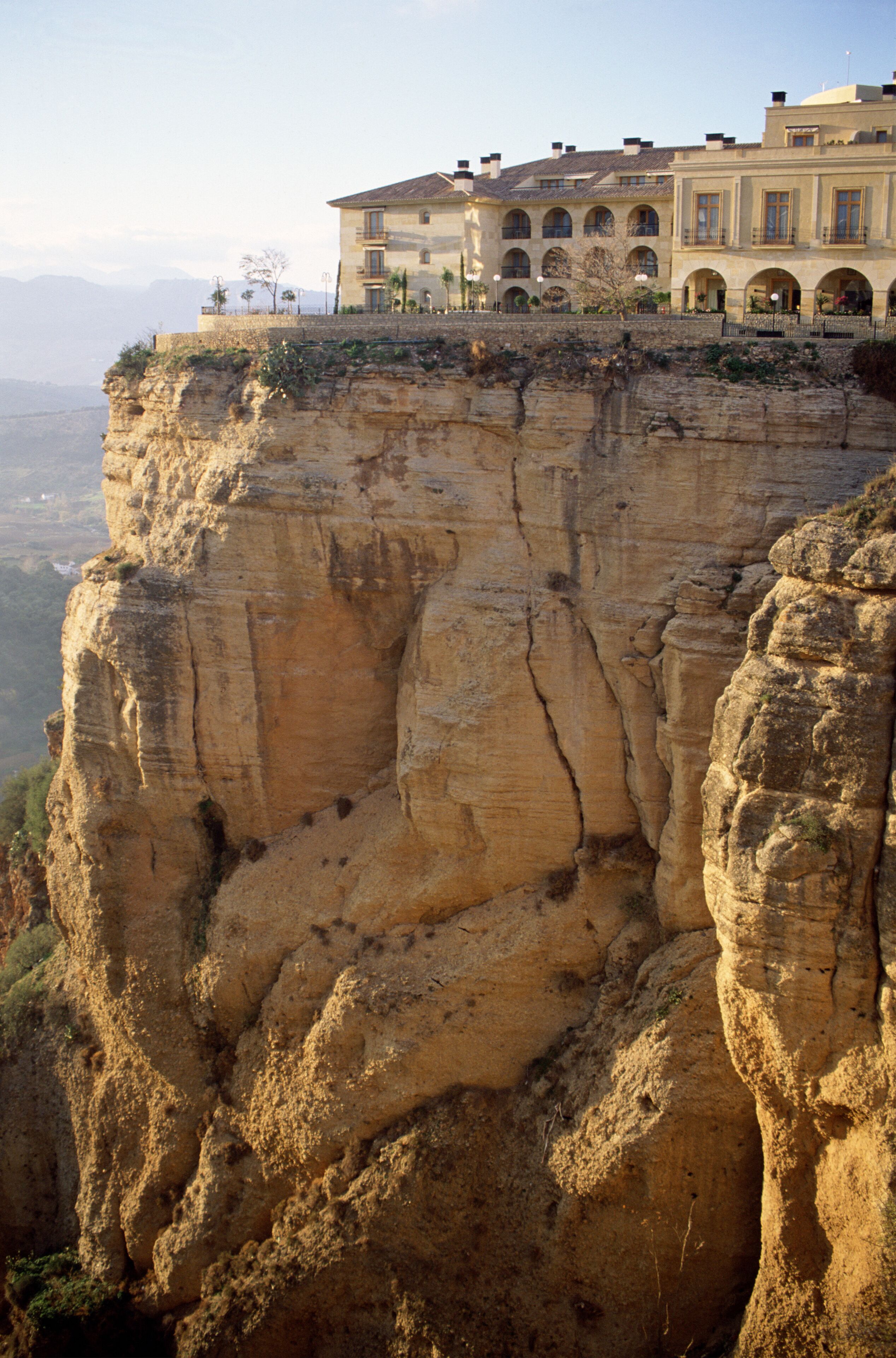 A cliff with a building on top.