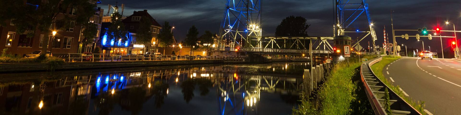 Vertical lift bridge of Waddinxveen, a town near the city of Gouda, Holland during blue hour. The bridge over the canal Gouwe is illuminated by blue light beams at night.