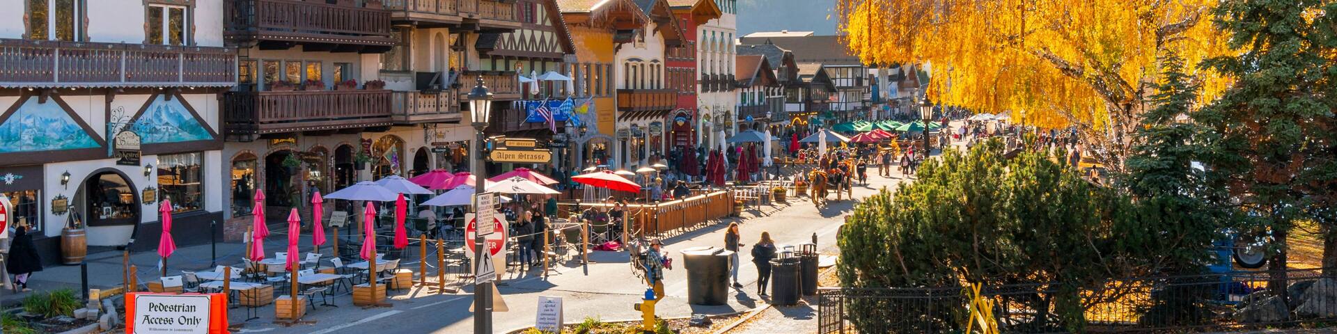 Autumn afternoon at the Bavarian themed village of Leavenworth, Washington, in the Inland Northwest of the United States, with themed sidewalk cafes and shops along the pedestrian only main street.