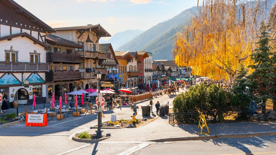 Autumn afternoon at the Bavarian themed village of Leavenworth, Washington, in the Inland Northwest of the United States, with themed sidewalk cafes and shops along the pedestrian only main street.