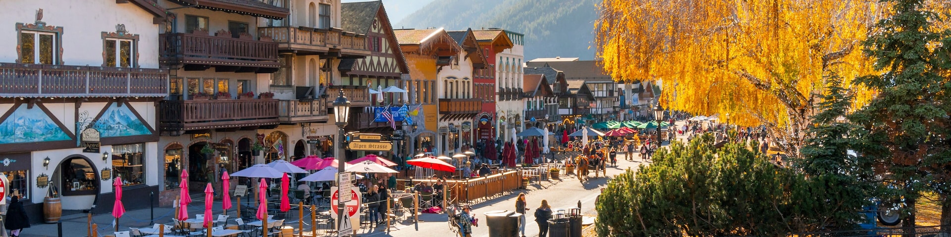 Autumn afternoon at the Bavarian themed village of Leavenworth, Washington, in the Inland Northwest of the United States, with themed sidewalk cafes and shops along the pedestrian only main street.