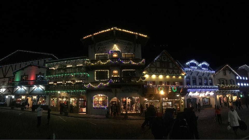 Een historisch stadsplein met traditionele gebouwen versierd met feestelijke verlichting.