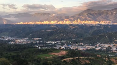A cityscape with a mountain range in the background.