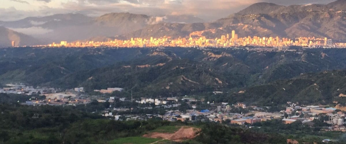 A cityscape with a mountain range in the background.